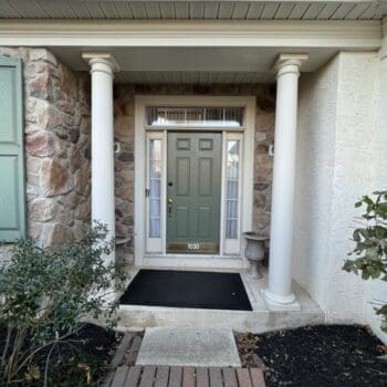 entryway with a green door to a home in Ambler, PA with stucco remediation