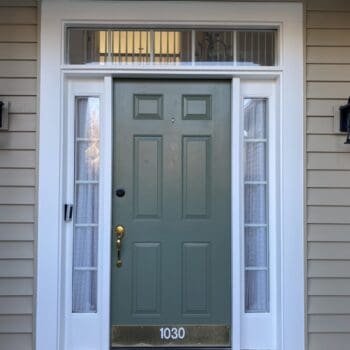 entryway with a green door and james hardie siding