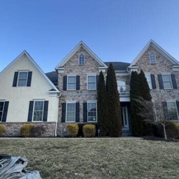 Front of Kong home in Harleysville PA before a stucco to CertainTeed siding transfromation