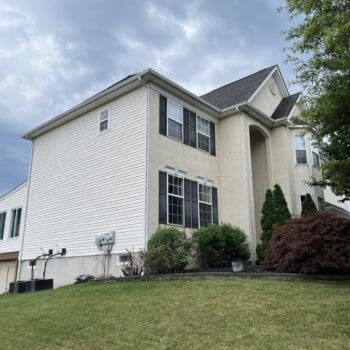 Side profile of front of Collegeville PA home with a stucco to vinyl siding transformation