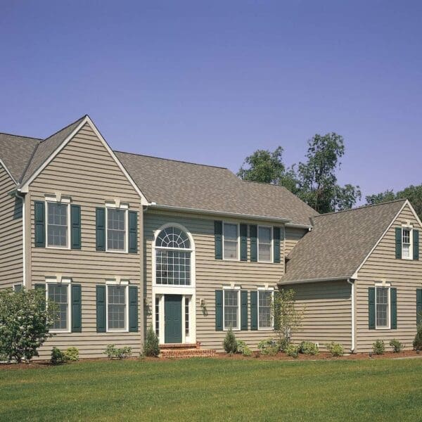 Standard CertainTeed brown vinyl siding on a home with green shutters
